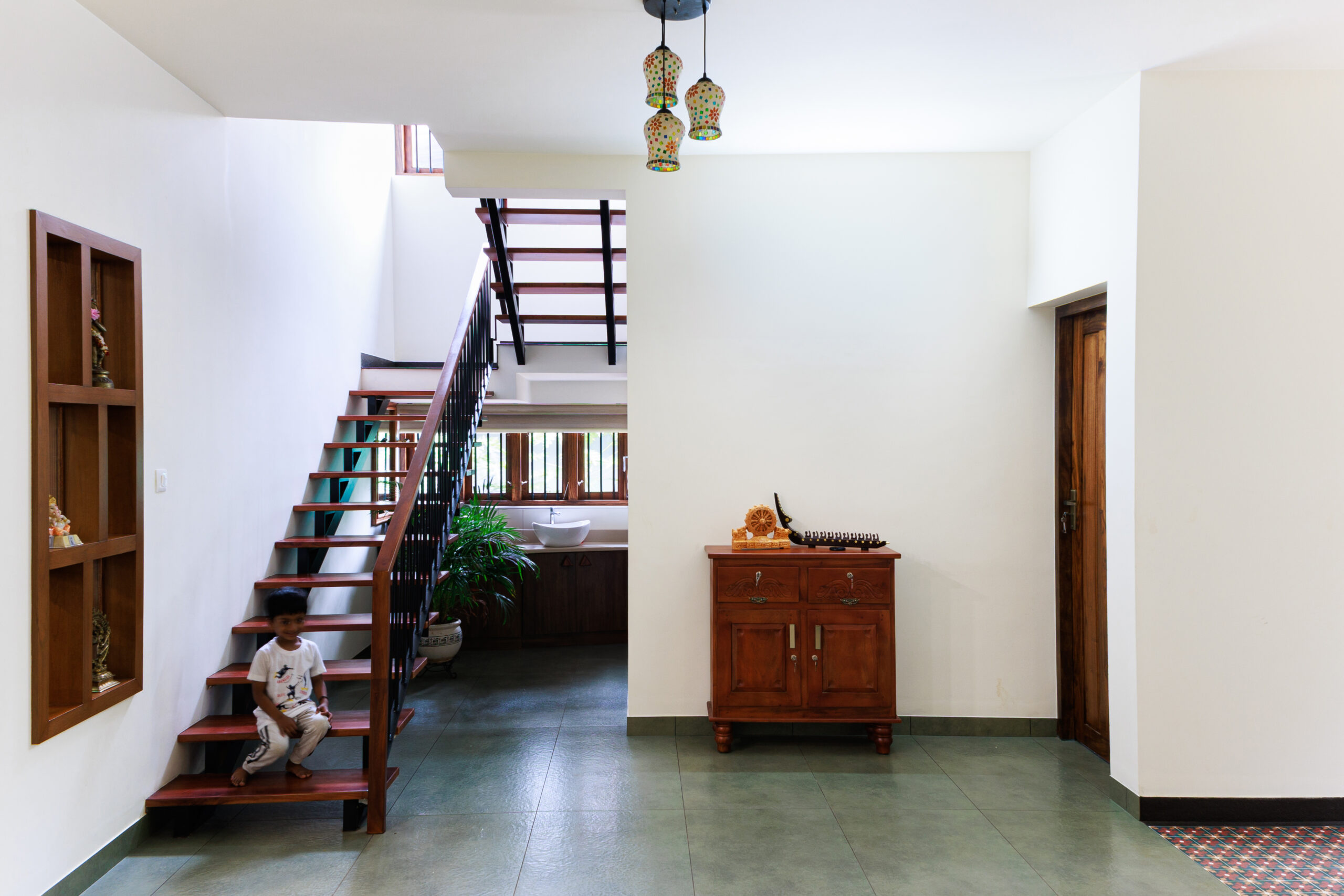 Modern home interior with wooden staircase and decor